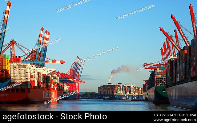14 July 2022, Hamburg: The container ship CMA CGM Zheng He (M) of the shipping company CMA CGM docks at the container terminal Eurogate in Waltershofer Hafen