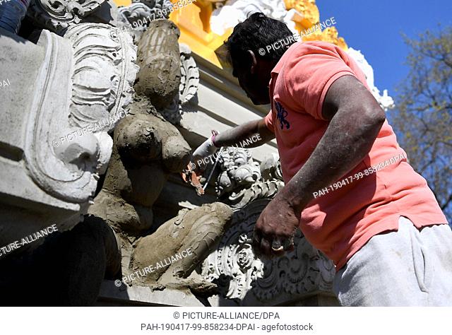 16 April 2019, Berlin: A man models the figure of a temple bearer at the Hindu temple on the Hasenheide. The Hindu temple is to become one of the largest in...