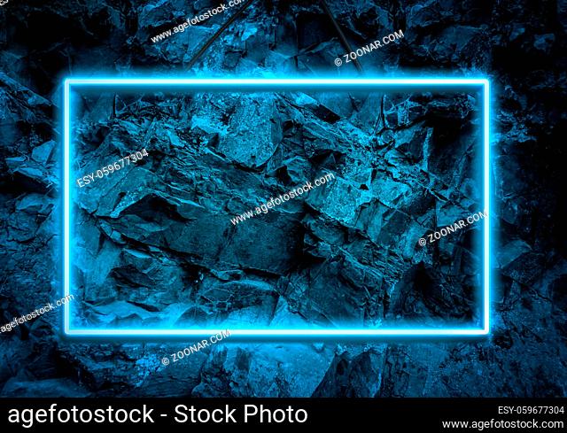 blue neon glowing frame on a background of a layer of stones, copy space