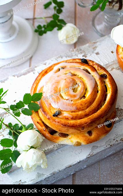 Cinnamon bun swirled with raisins, vintage and shabby style, vertical image