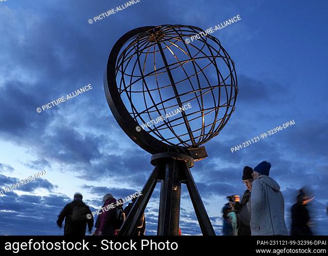 24 August 2023, Norway, Nordkap: In the early morning, tourists visit the globe on the North Cape's slate plateau, which is located around 300 meters above the...