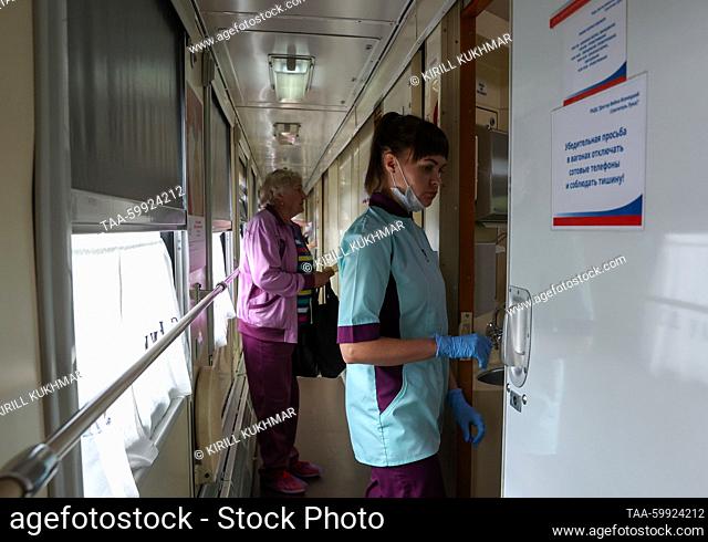 RUSSIA, KRASNOYARSK REGION - JUNE 19, 2023: A medical worker and a patient are seen in a railway car of the Doctor Voino-Yasenetsky-St Luke mobile diagnostic...