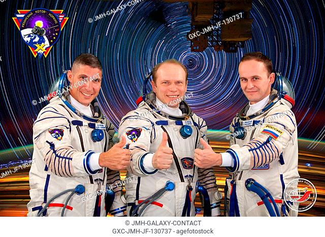 Russian cosmonaut Oleg Kotov (center), Expedition 37 flight engineer and Expedition 38 commander; along with NASA astronaut Michael Hopkins (left) and Russian...