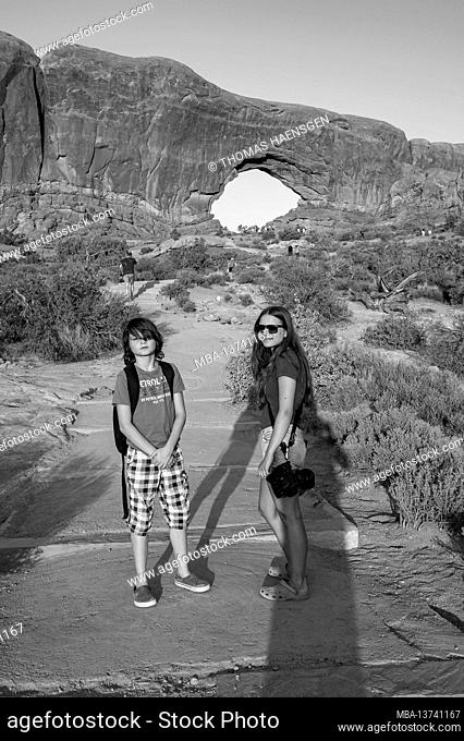Girl and Boy in front of the North Window Arch. Arch on the north side of the Windows, a sandstone fin featuring 2 massive
