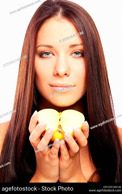 Beautiful woman with apple in hands against white background