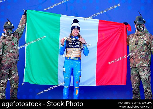 16 February 2021, Italy, Cortina D'ampezzo: Alpine Skiing: World Championship, Parallel, Women: Marta Bassino from Italy with her gold medal in front of the...