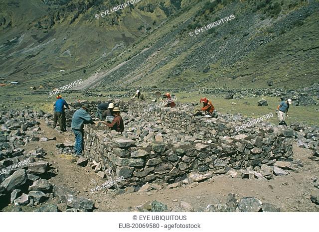 Local Quechuan men building a house