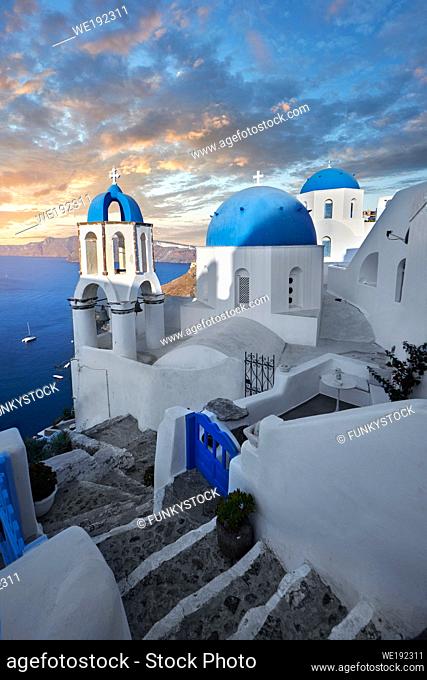Sunset over the traditional Greek Orthodox churches of Oia (ia), Cyclades Island of Thira, Santorini, Greece. . . The settlement of Oia had been mentioned in...