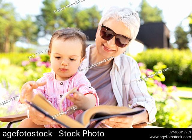 grandmother and baby granddaughter reading book