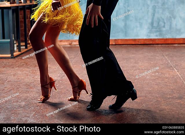 Ballroom dance samba. Close up of dancing legs couple of dancers in studio