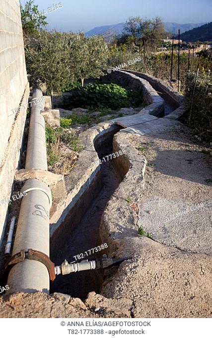 landscape irrigation canal and pipe in orchard, Alhama de Almeria, Andalucia, Spain, Europe