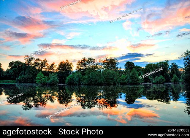 Sunset above Fulda river in Aueweiher Park in Fulda, Hessen, Germany