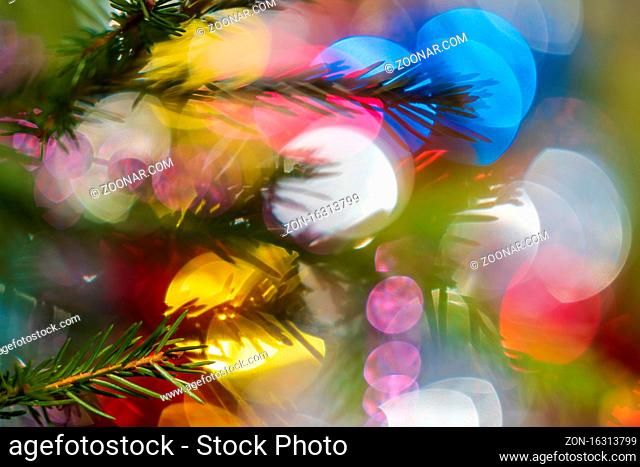 Silhouette of branch Xmas tree with needles. Happy New Year ornament decorations, colorful defocused abstract blurry bokeh background