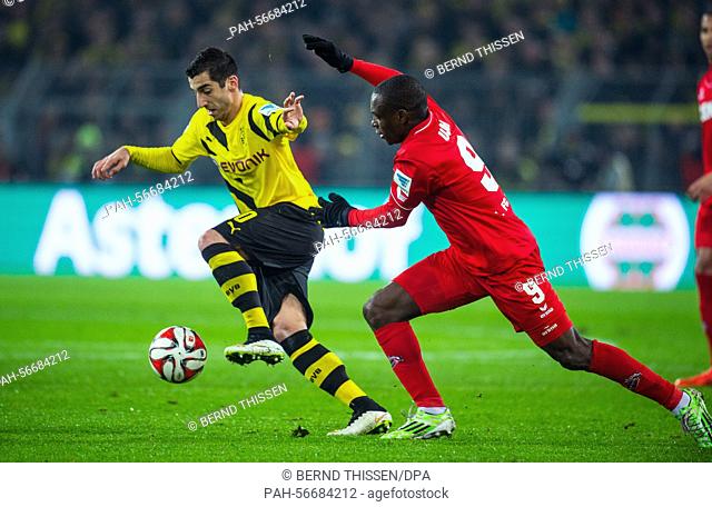 Dortmund's Henrikh Mkhitaryan (L) and Koeln's Anthony Ujah vie for the ball during the German Bundesliga soccer match between Borussia Dortmund and 1