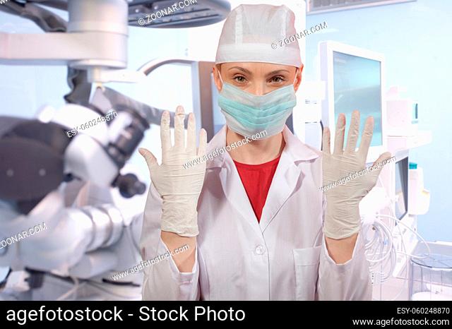 Young woman - doctor in front of medical equipment in modern hospital