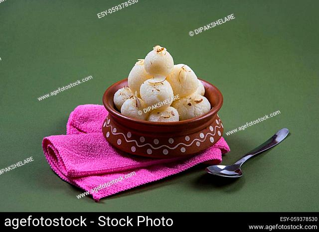 Indian Sweet - Rasgulla, Famous Bengali sweet in clay bowl with napkin