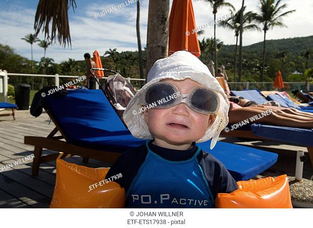 Small boy in a swimming pool with diving goggles, Guadeloupe