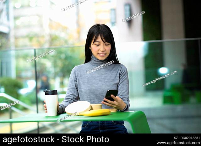 Woman having lunch in business area