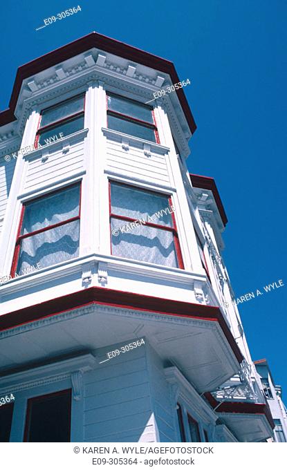 Victorian house, white with red trim, against blue sky, San Francisco, California, USA
