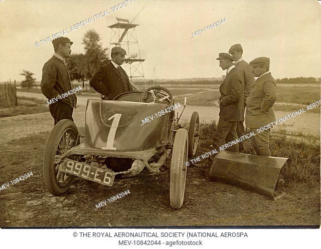 Wilbur Wright examining the engine of the Delage which won the coup des Voiturettes at Dieppe, at Camp d’Auvours, Le Mans, 1908