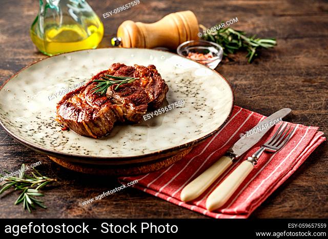 Fresh grilled beef steak Prime Black Angus Chuck roll steak on a dish on a wooden table