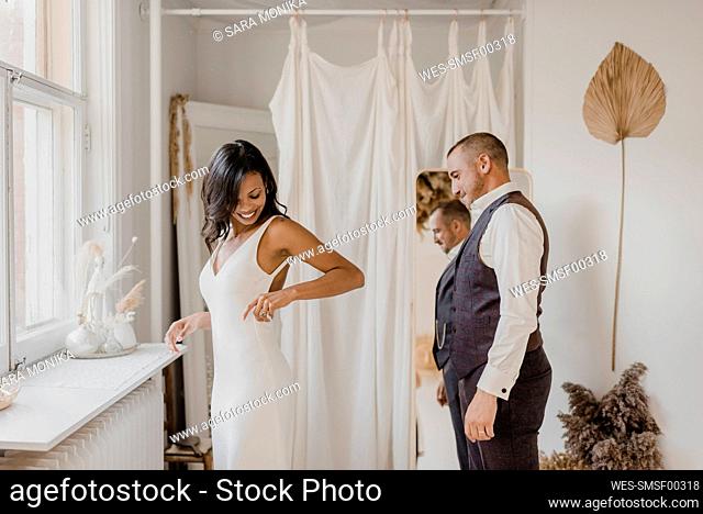 Heterosexual couple looking at each other while standing at home