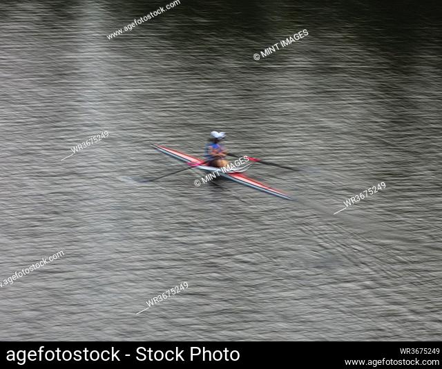 A single scull boat and rower on the water, view from above
