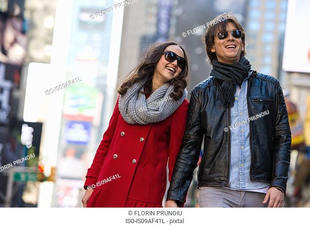Young tourist couple holding hands, New York City, USA