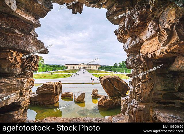 Vienna, Austria. Schonbrunn Palace or Schloss Schoenbrunn framed by fountain shape. Imperial residence in Vienna and a major tourist attraction in Vienna
