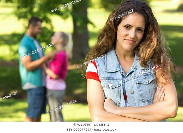 Angry woman with man and girlfriend in background at park