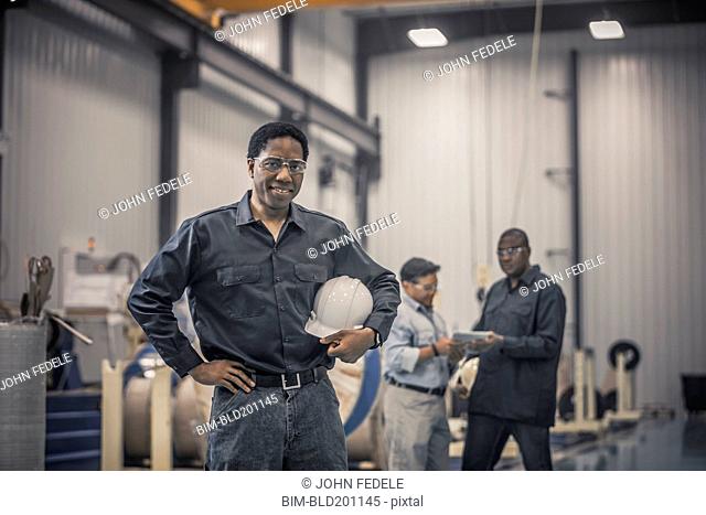 African American worker standing in factory