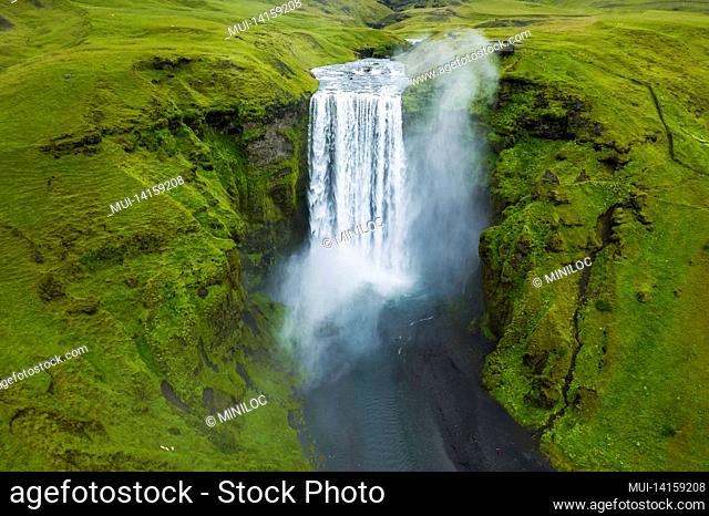 aerial drone view of skogafoss waterfall in iceland, one of the most famous tourist visited attraction and landmark