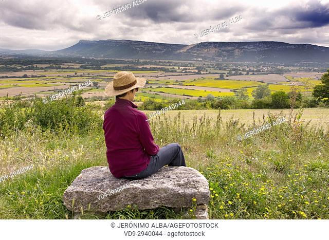 Woman in a field flowers in summer. Las Merindades County Burgos, Castile and Leon, Spain, Europe