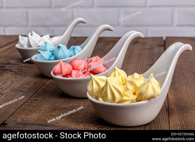 Rainbow sweets on wood table and brick background