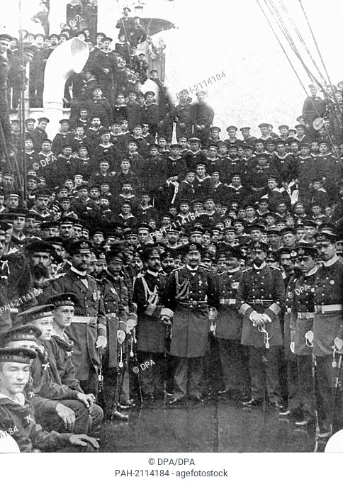 Emperor Wilhelm II. (m) and Prince Henry (leaning onto his sword with two hands) among the officers and crew of the ship ""Deutschland"" (translates as...
