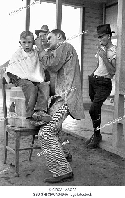 Boy Getting Haircut, Community Barber Shop, Migrant Camp, Kern County, California, USA, Dorothea Lange, Farm Security Administration, November 1936