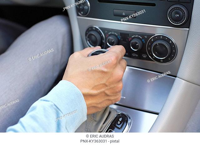 Man shifting automatic car gear