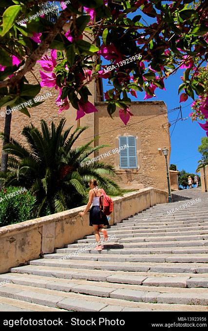 young woman on the stairs to the Calvary in Arta, Mallorca, Balearic Islands, Spain