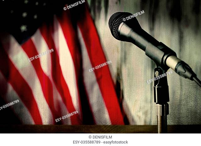 Old american flag and microphone. Microphone beside aged flag. Hear the sounds of past. Journey into the old times