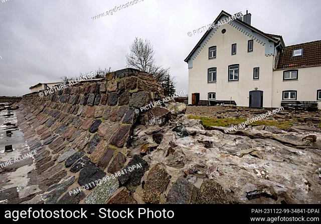 PRODUCTION - 09 November 2023, Schleswig-Holstein, Maasholm: Large stones have been torn out of a wall on Lotseninsel by the storm surge