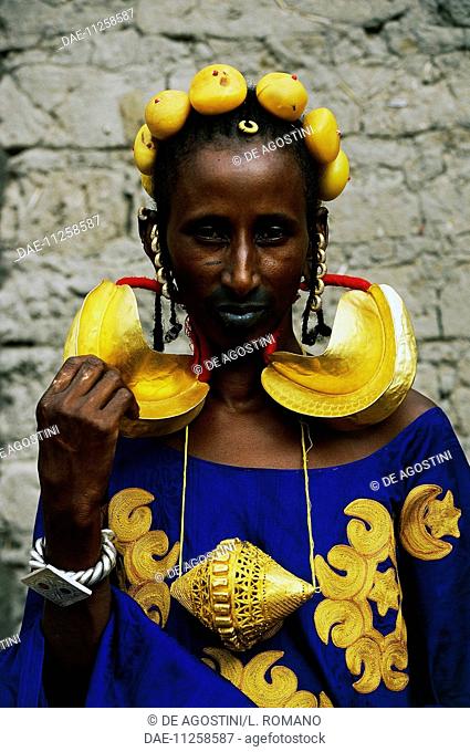 Fulani woman from a wealthy Marabout family, wearing clothes and jewelry for a wedding, village near Mopti, Mali