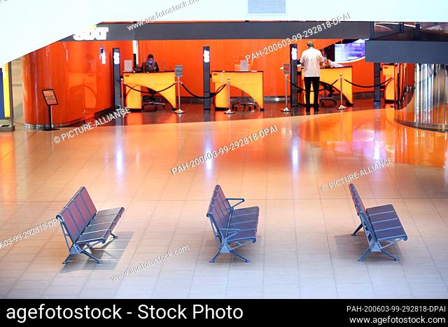 29 May 2020, Hamburg: Empty benches can be found in the arrivals area in Terminal 2 at Hamburg Airport. In the blurred background you can see a counter of the...