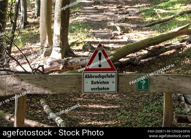 07 August 2020, Mecklenburg-Western Pomerania, Sassnitz: A sign with the inscription ""Abort danger - no trespassing"" is located on the steep coast in the...
