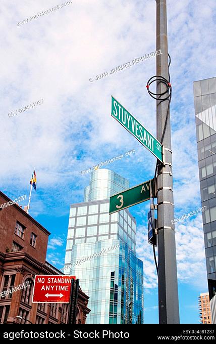 Low angle view of road sign against skyline in New York City