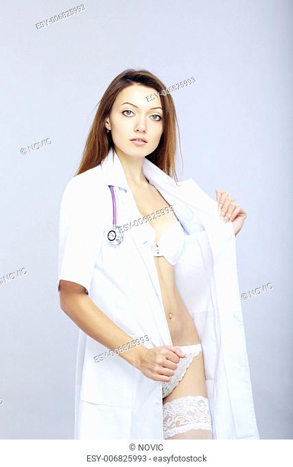 Sexy female doctor revealing medical uniform with stethoscope
