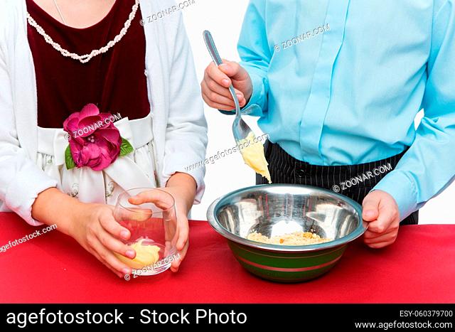 Children making christmas cake pop dessert on red table