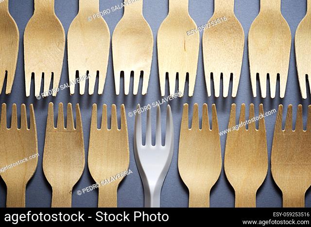 Disposable wooden and plastic cutlery on a table