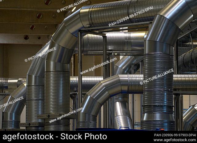 06 September 2023, Saxony-Anhalt, Sülzetal: Exhaust pipes lead through a hall of the company ""Li-Cycle"" to containers. The company recycles batteries there...
