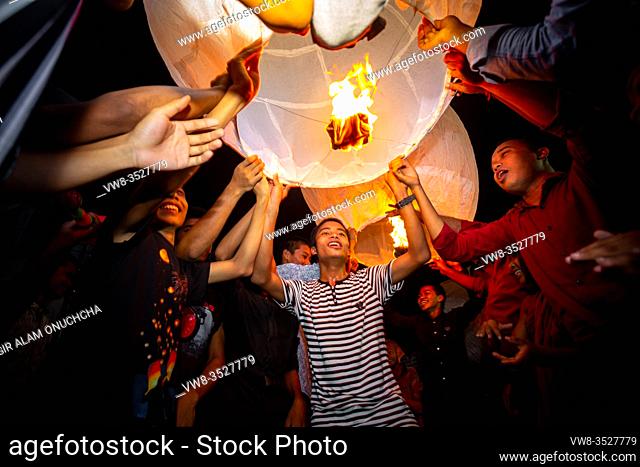 Bangladesh - October 13, 2019: Buddhist devotees set off giant paper lanterns into the night sky to celebrate 'Probarona Purnima' at Bandarban, Bangladesh