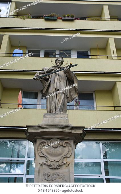 Statue of a saint in front of a residential building central Warsaw Poland Europe